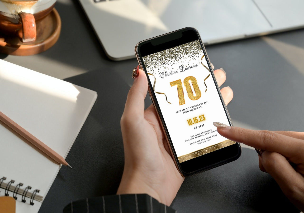 Person holding a phone displaying a customizable White Gold Confetti 70th Birthday Evite from URCordiallyInvited.