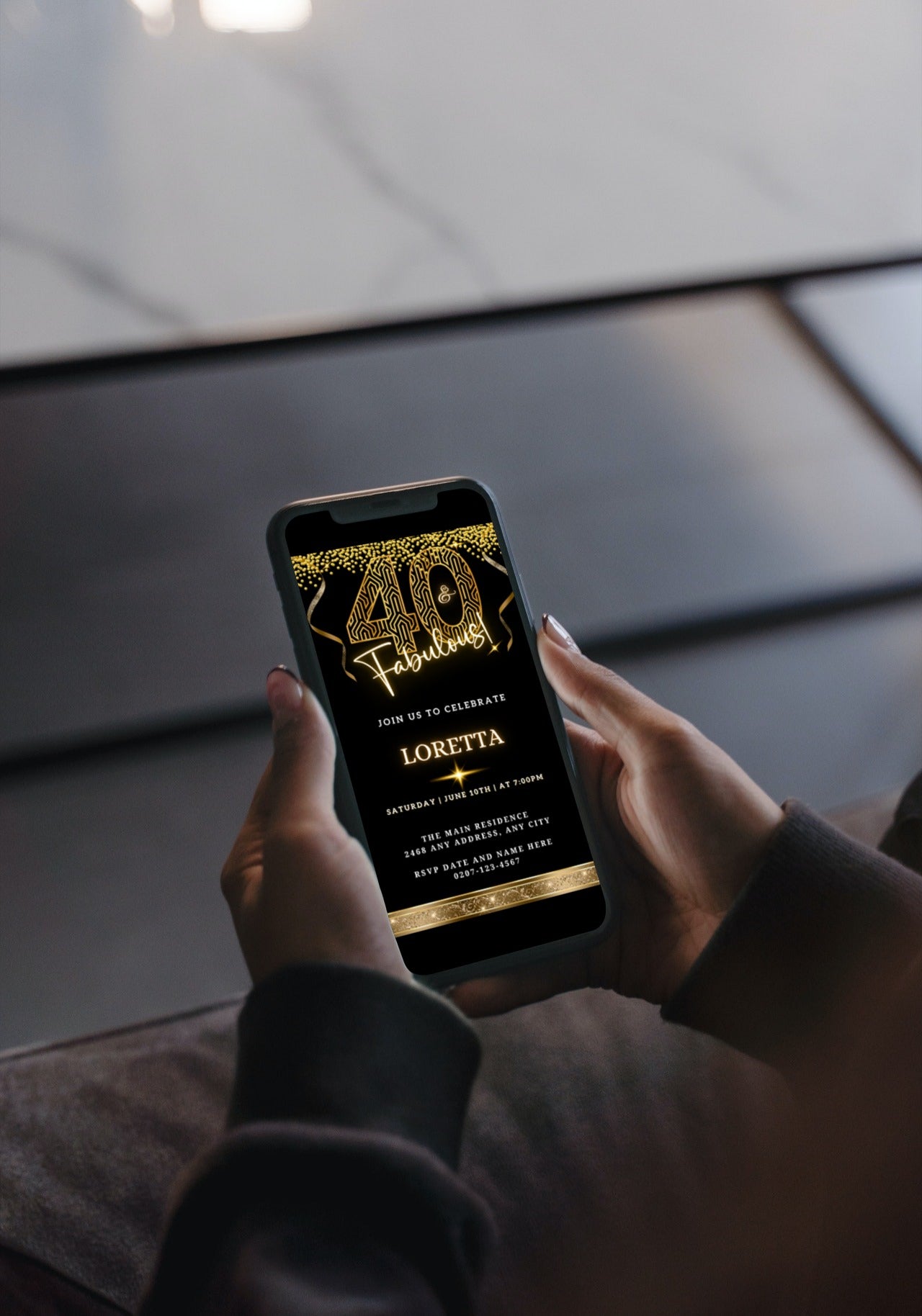 Person holding a phone displaying a Gold Neon Glitter Black | 40 & Fabulous Party Evite.