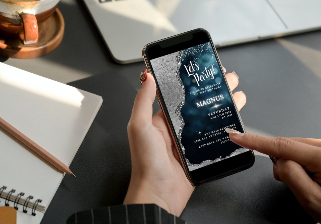 Person holding a phone displaying an editable Navy Silver Glitter Birthday Evite template from URCordiallyInvited.