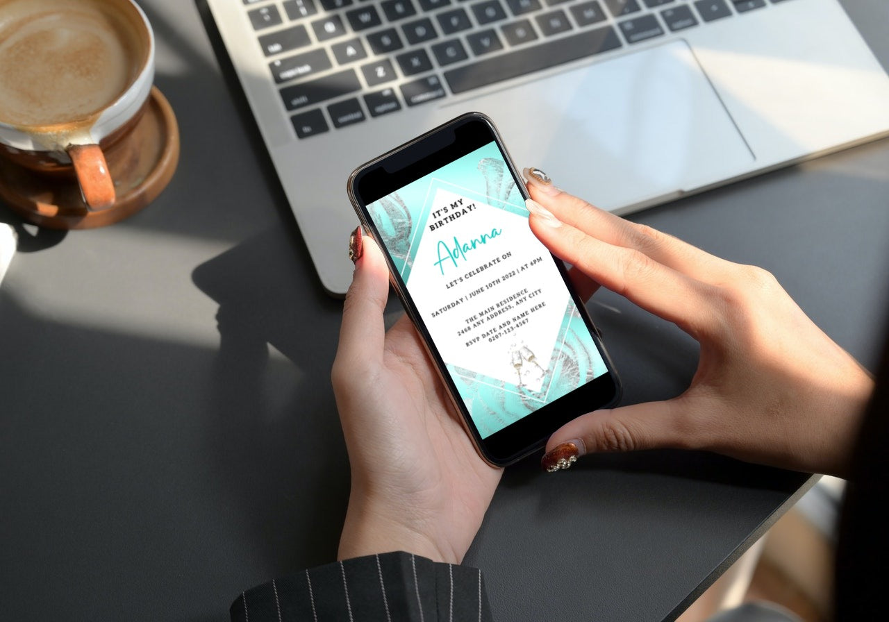 Person holding a smartphone displaying the Teal White Silver Floral Customisable Birthday Evite from URCordiallyInvited.