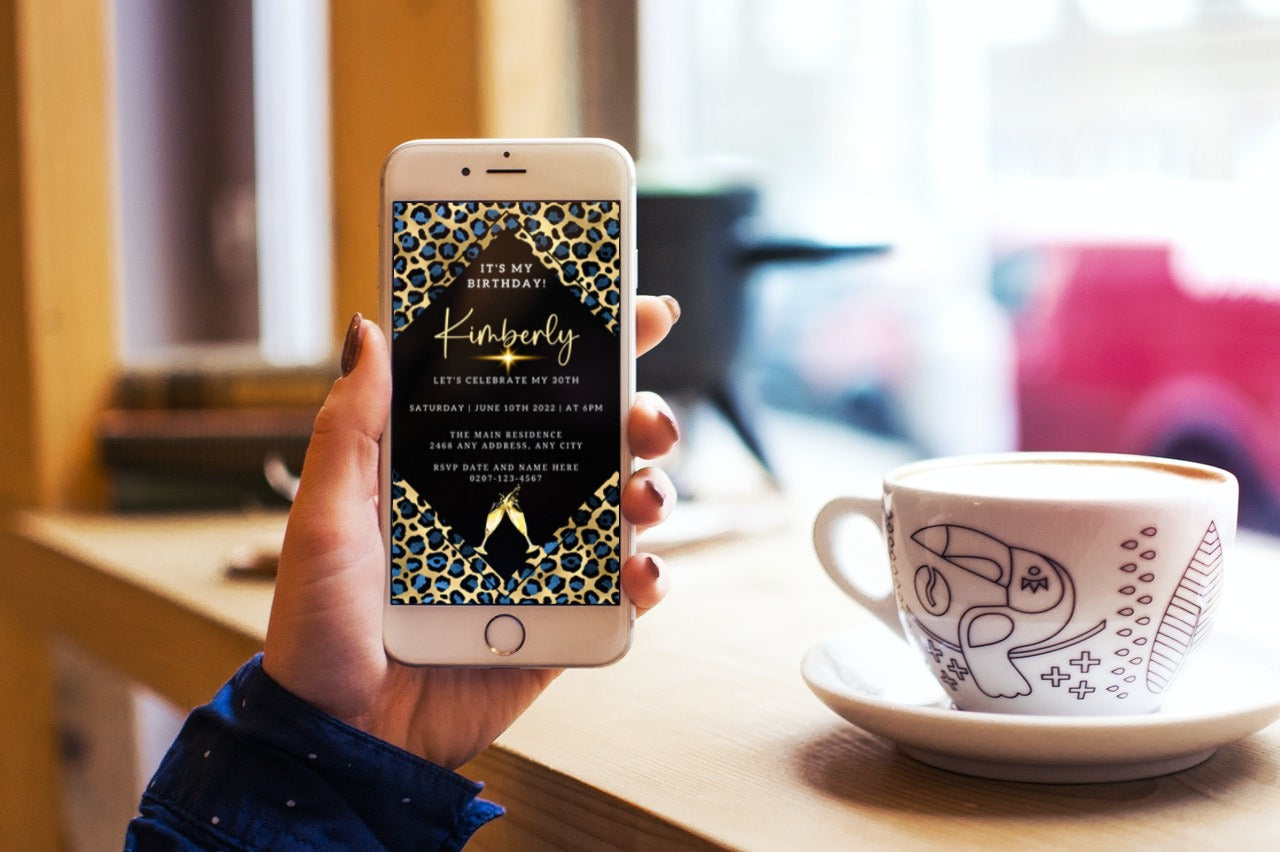 Hand holding a smartphone displaying a Blue Gold Leopard Animal Print Customisable Party Evite.