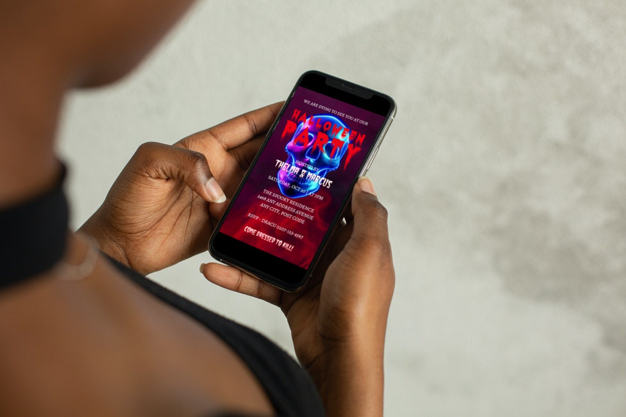 Person holding a phone displaying the Blue Smoking Neon Skull Halloween Party Video Invite.