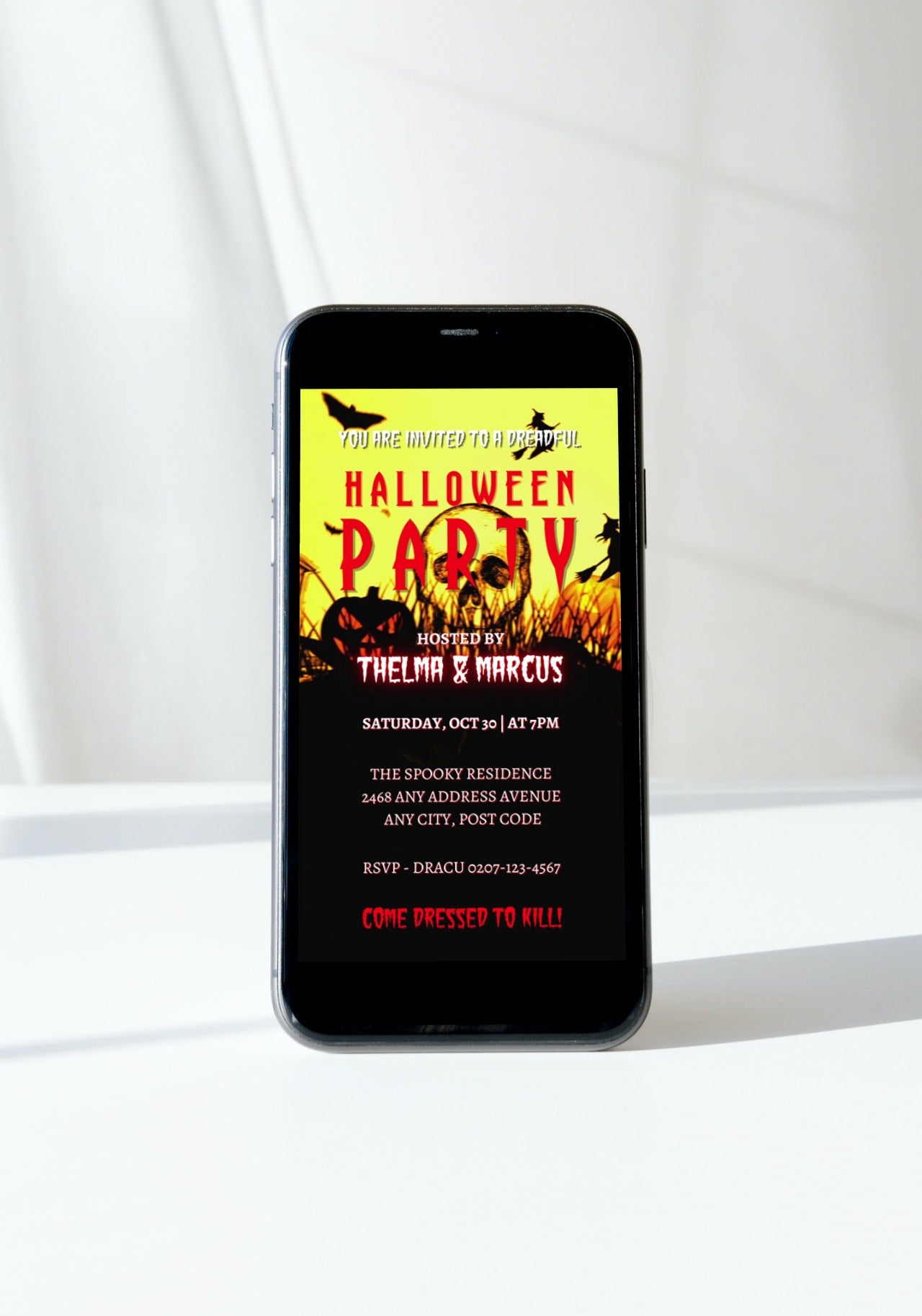 Cell phone displaying a digital editable Halloween Party Video Invite, featuring spooky bats and pumpkins, customizable via Canva.
