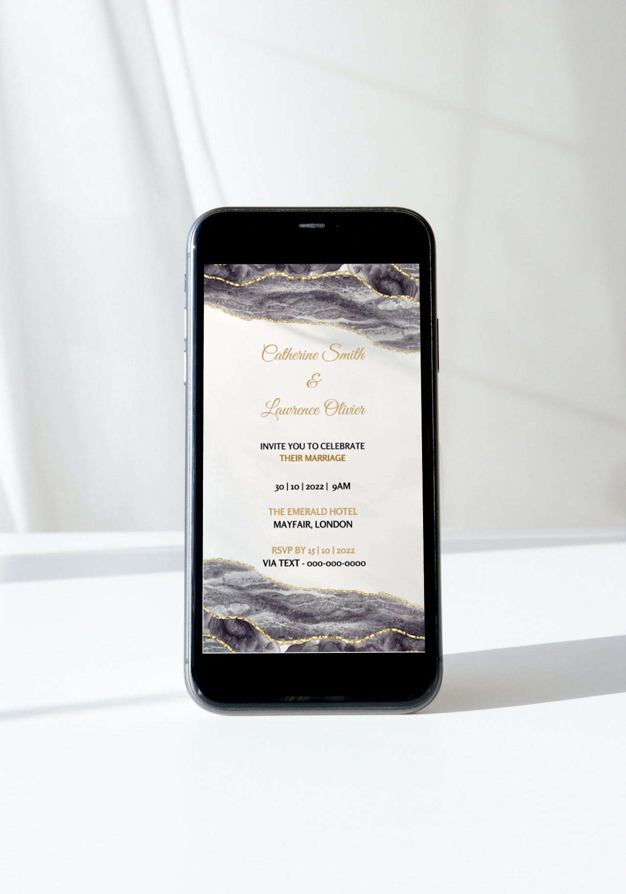 Black Gold Agate customizable digital wedding video invitation displayed on a smartphone screen, ready for personalization using the Canva design app.