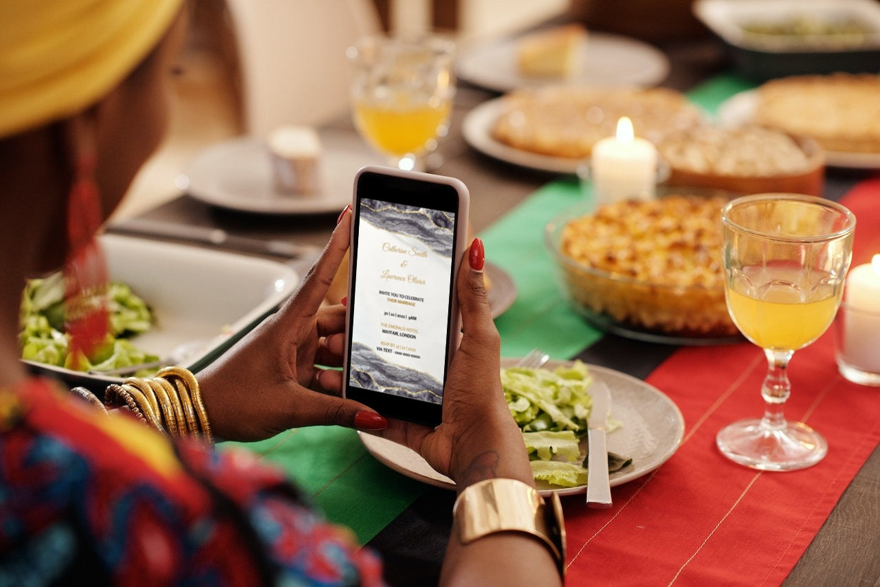 Person holding a phone with a digital wedding invitation template displayed, showcasing the Black Gold Agate customizable design for personalizing event details.
