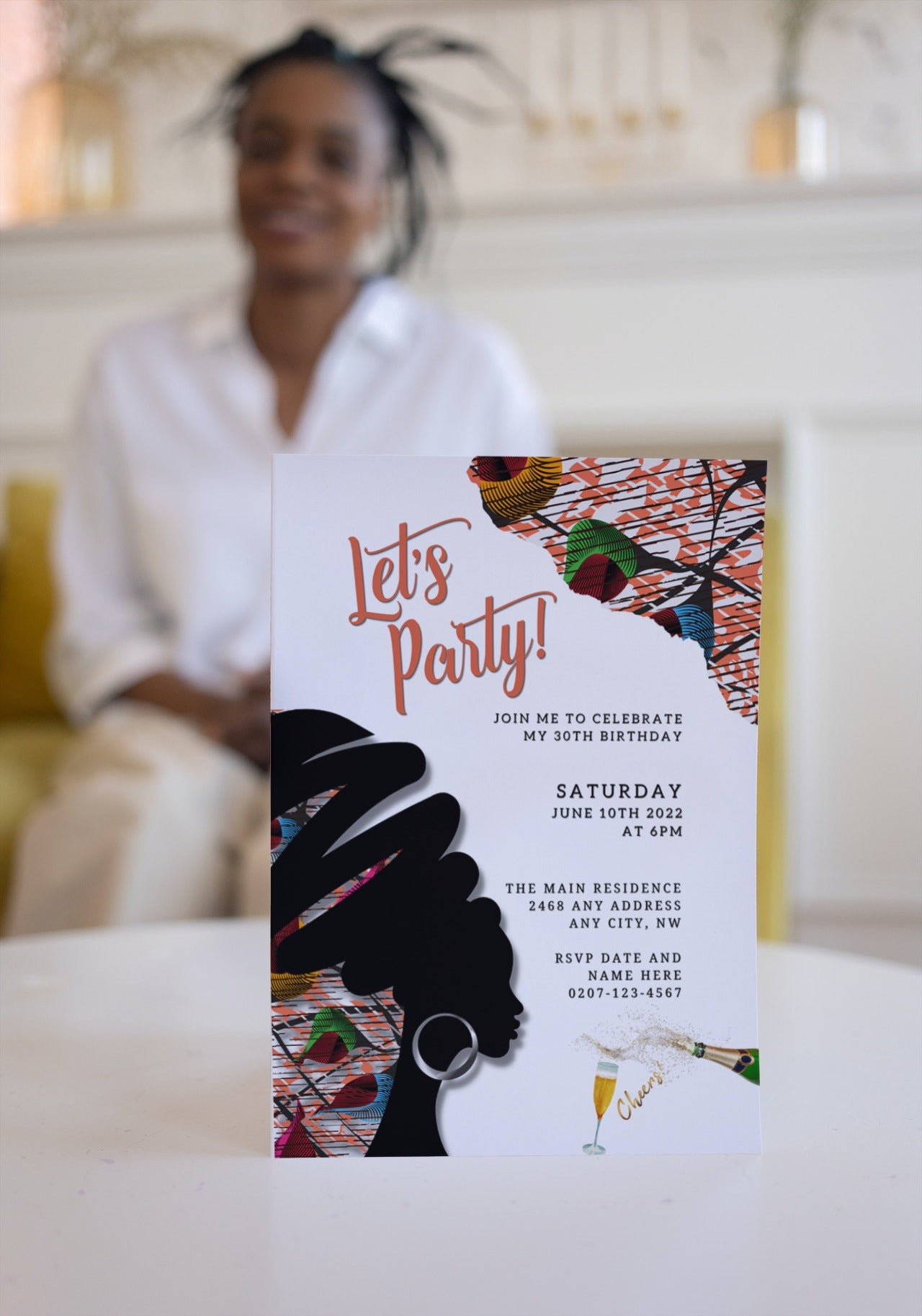 Woman in white shirt holding a customizable Digital & Printable Purple Ankara African Woman Silhouette Party Evite card, ideal for DIY event invitations.