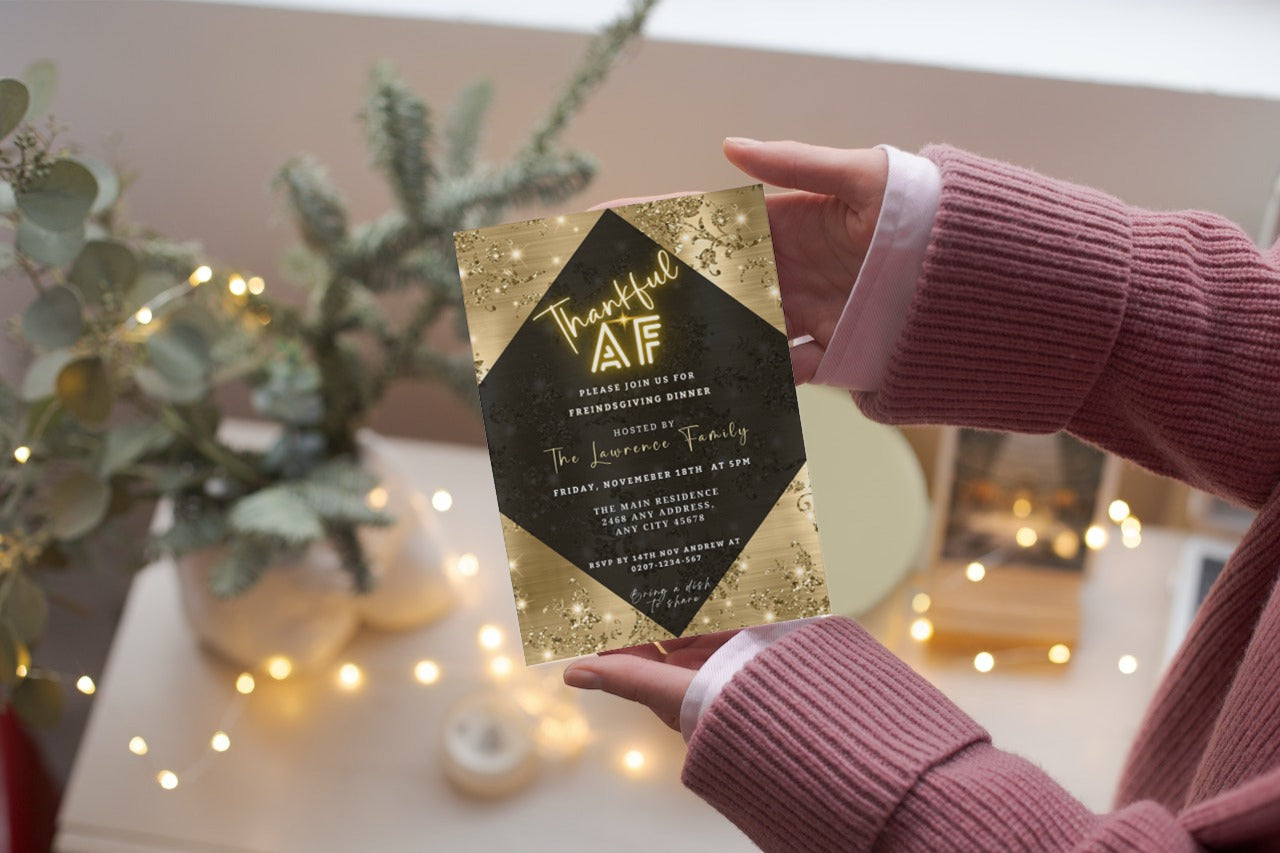 Hand holding the Thankful AF Golden Leaves Diamond Thanksgiving Dinner Evite, showcasing a customizable digital invitation template available for download and personalization via Canva.