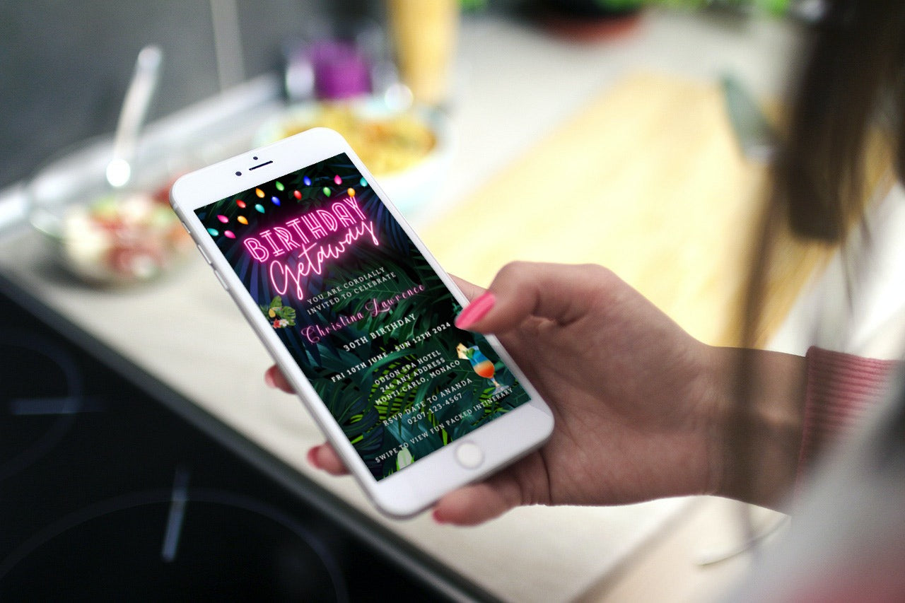 Hand holding a phone displaying a customizable Tropical Destination Neon Pink | Birthday Getaway Evite for smartphones.