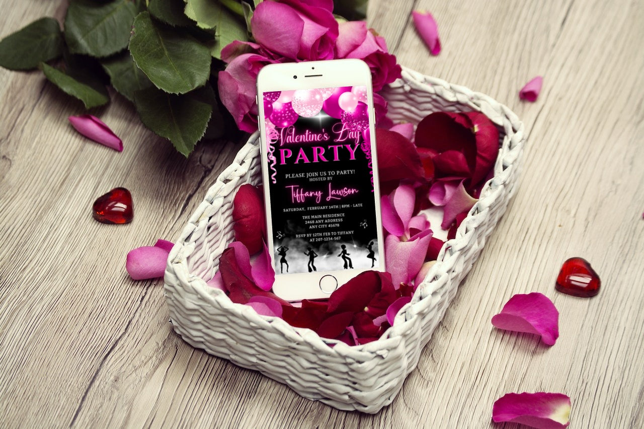Cellphone in white basket with pink petals, displaying editable Smoking Dancers Pink Neon Balloons Valentine's Day Party Evite from URCordiallyInvited.