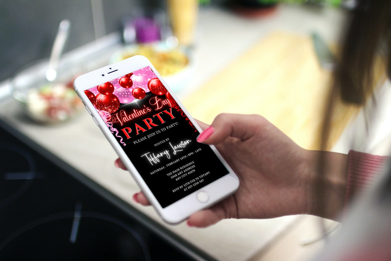Hand holding a smartphone displaying a customizable Neon Red Pink Balloons Valentines Party Evite.