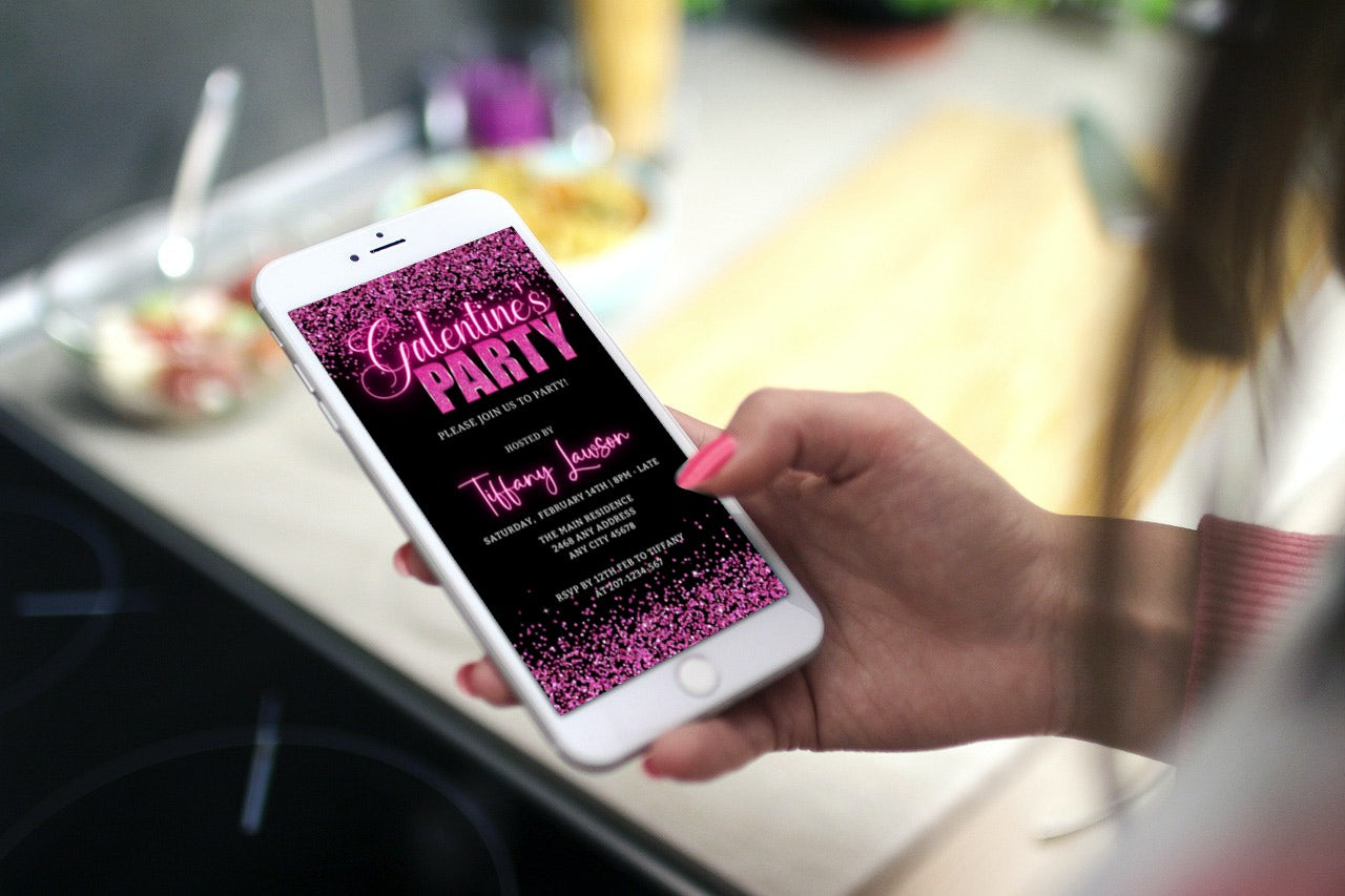 Hand holding a phone displaying Galentines Neon Pink Confetti | Valentines Party Evite, an editable digital invitation template for customization via Canva.