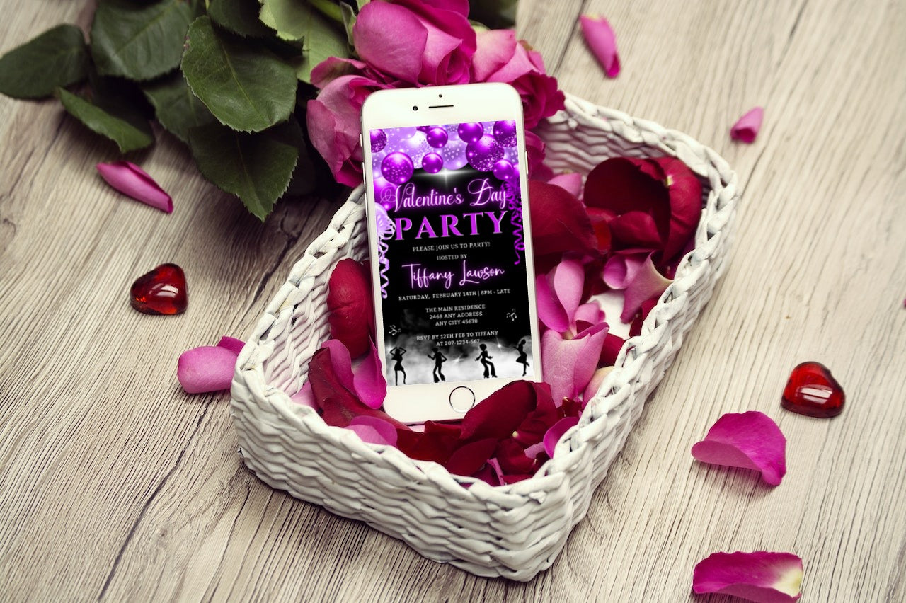 Cell phone displaying Smoking Dancers Neon Purple Valentines Party Evite, set in a basket of rose petals.