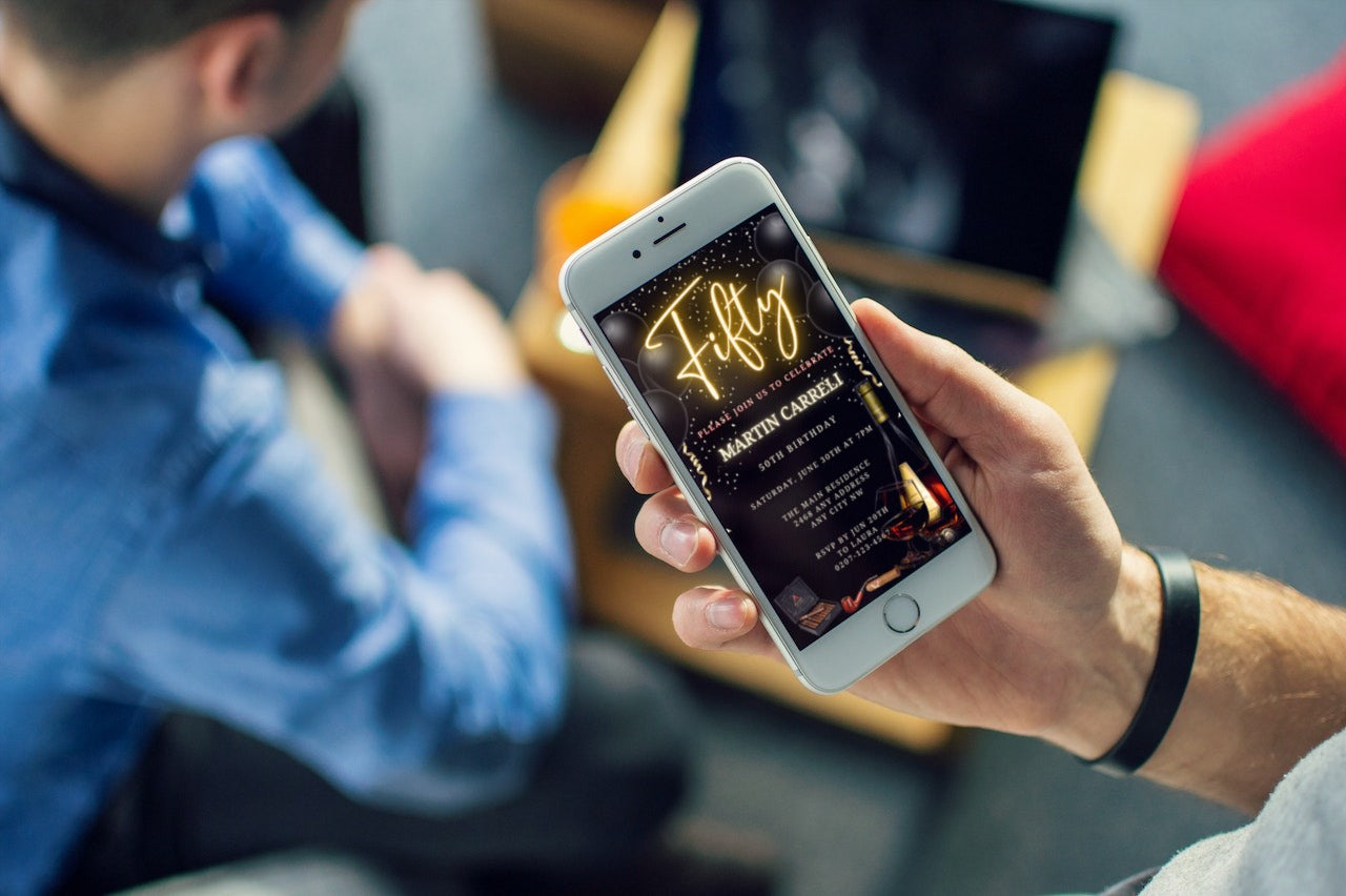 Person holding a smartphone displaying a customizable Digital Black Gold Neon Men's 50th Birthday Evite template from URCordiallyInvited.