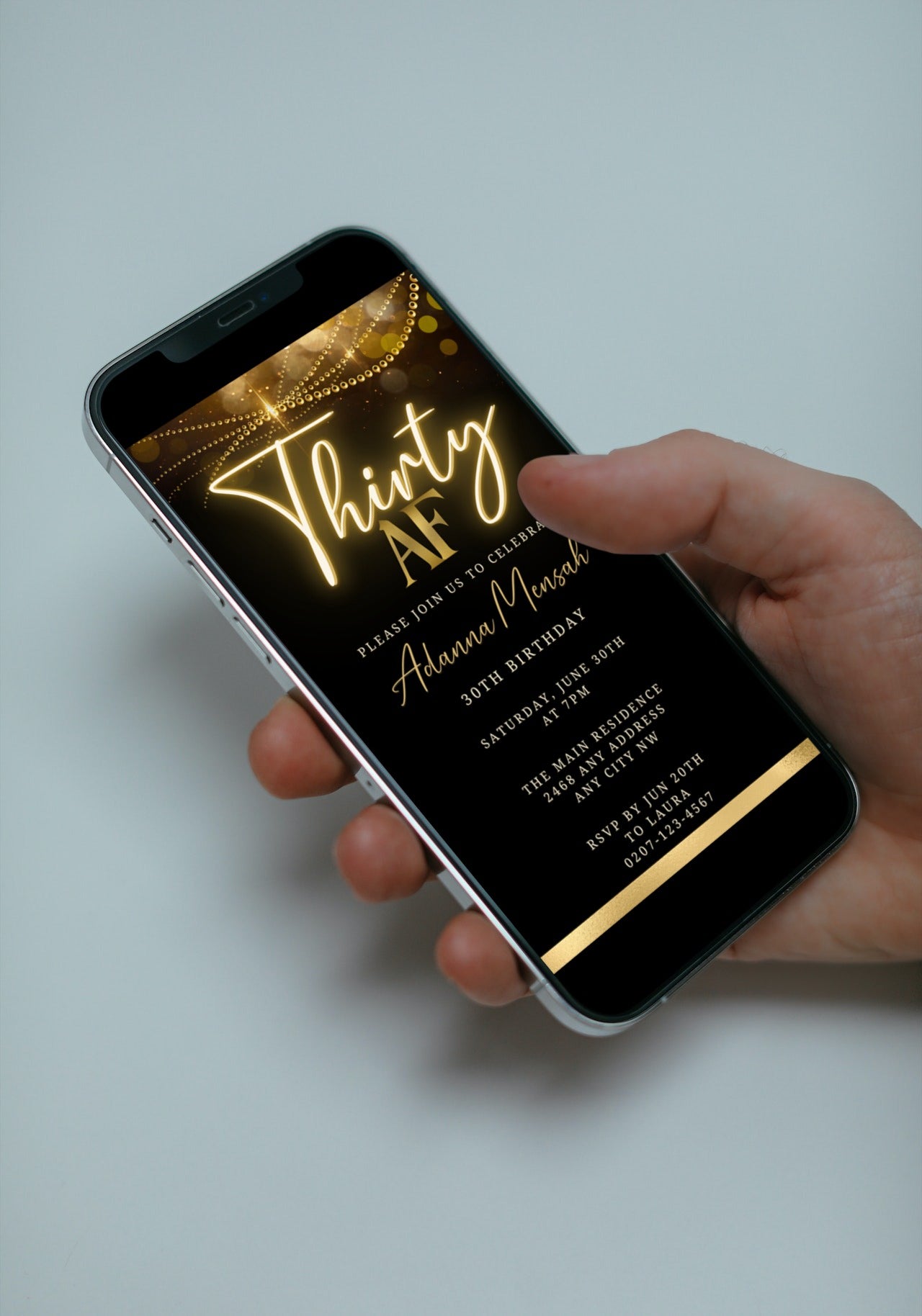 Hand holding a phone displaying a customizable Black Gold Neon Sparkle 30AF Birthday Evite, ready for personalizing and electronic sharing via smartphone.