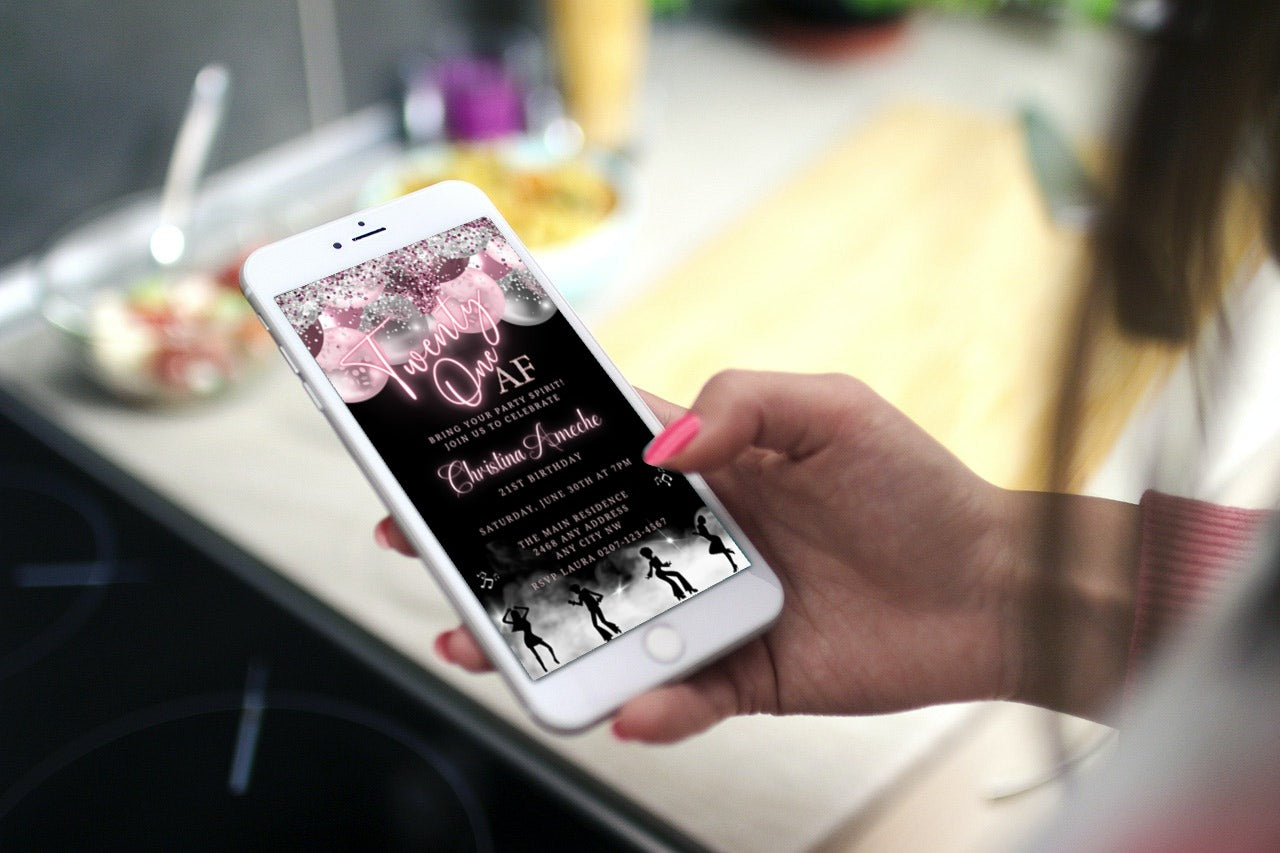 Hand holding a smartphone displaying a Mauve Pink Silver Neon | 21AF Birthday Video Evite template, customizable via Canva for digital invitations.