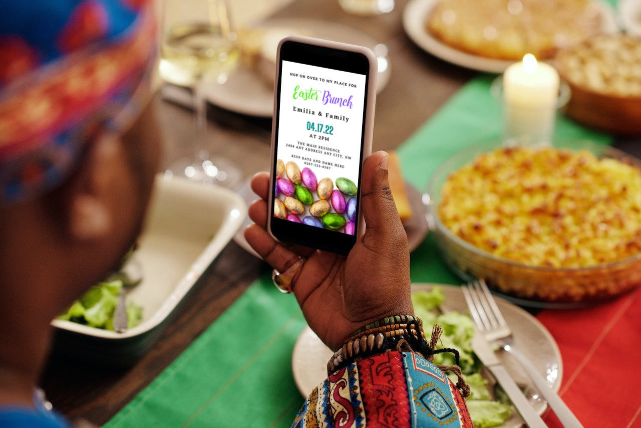 Person holding a smartphone displaying a colorful Easter egg Evite for personalized digital invitations.