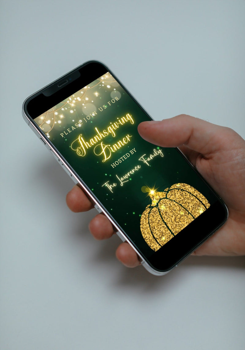 Hand holding a smartphone displaying the Green Gold Neon Pumpkin | Thanksgiving Dinner Video Invite template customizable via Canva.