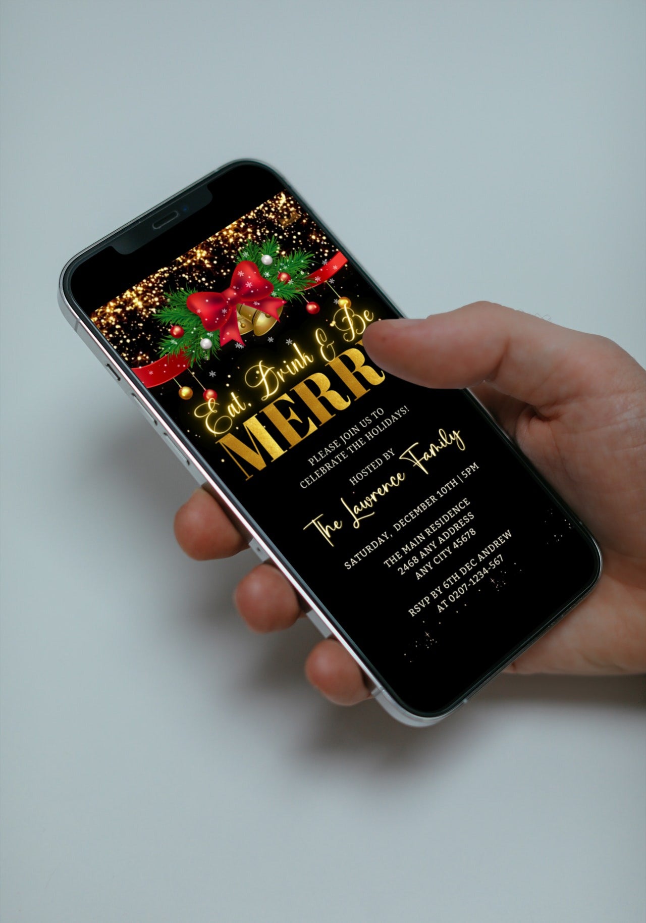 Hand holding a smartphone displaying a customizable Red Bell Bow Merry Glitter Christmas Party Video Invite.