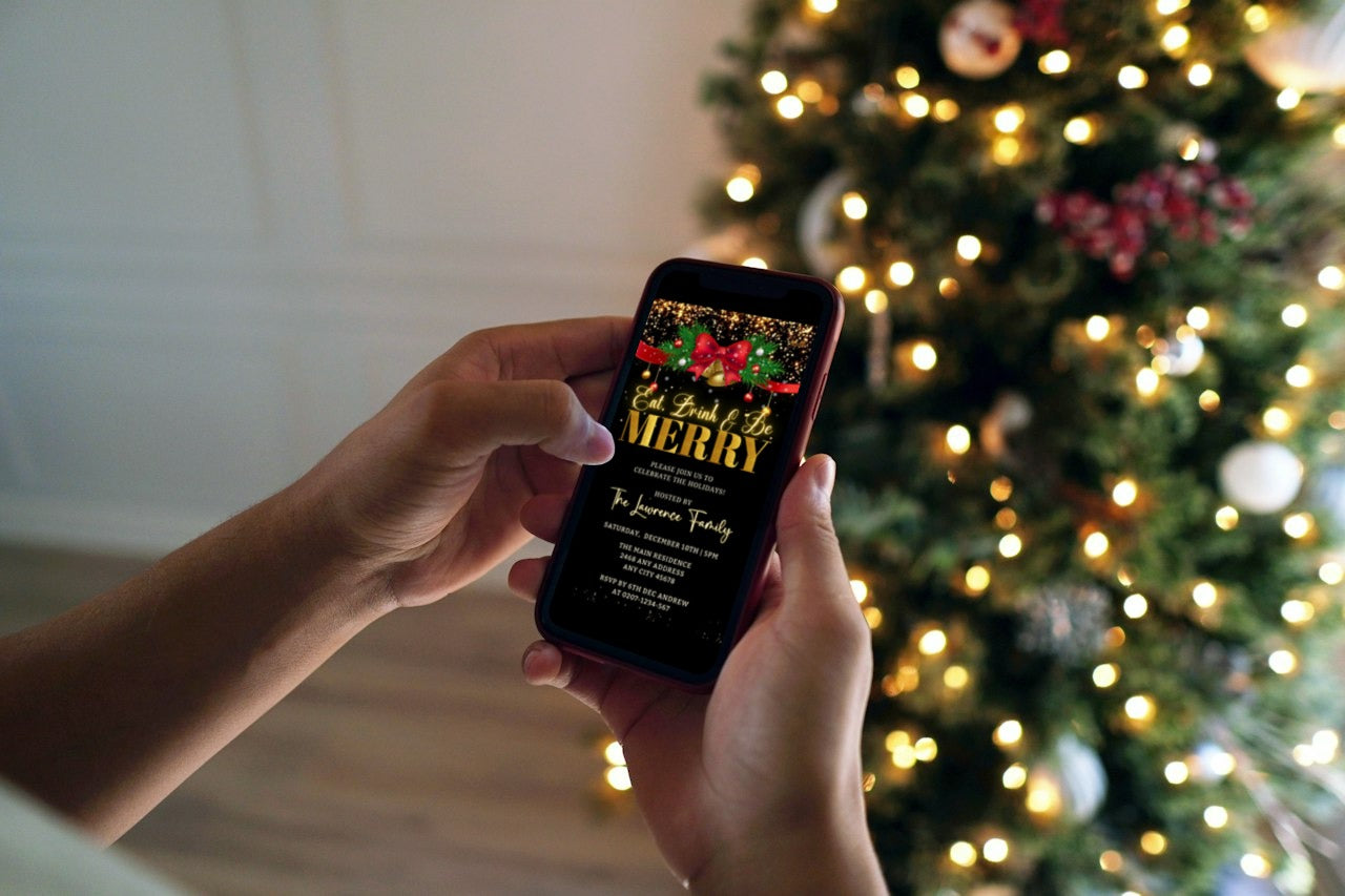 Person holding a phone displaying the Red Bell Bow Merry Glitter Christmas Party Video Invite template, with a Christmas tree in the background.