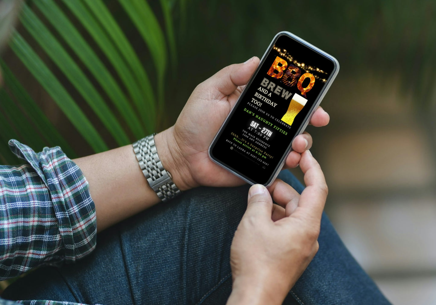 Person holding a smartphone with BBQ Flame & Brew Birthday Digital Video Party Invite displayed, customizable via Canva for easy event personalization and electronic sharing.