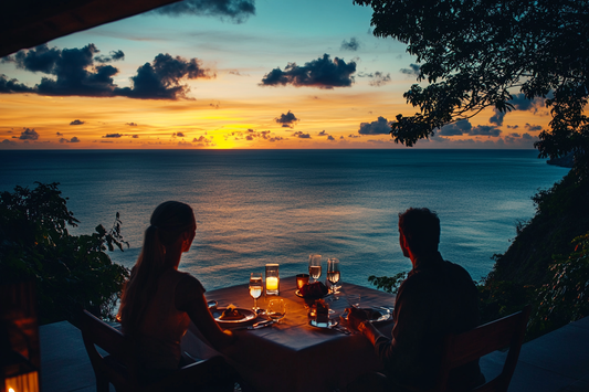 couple enjoying dinner overlooking sunset sea view by URCordiallyInvited customisable digital wedding invitations