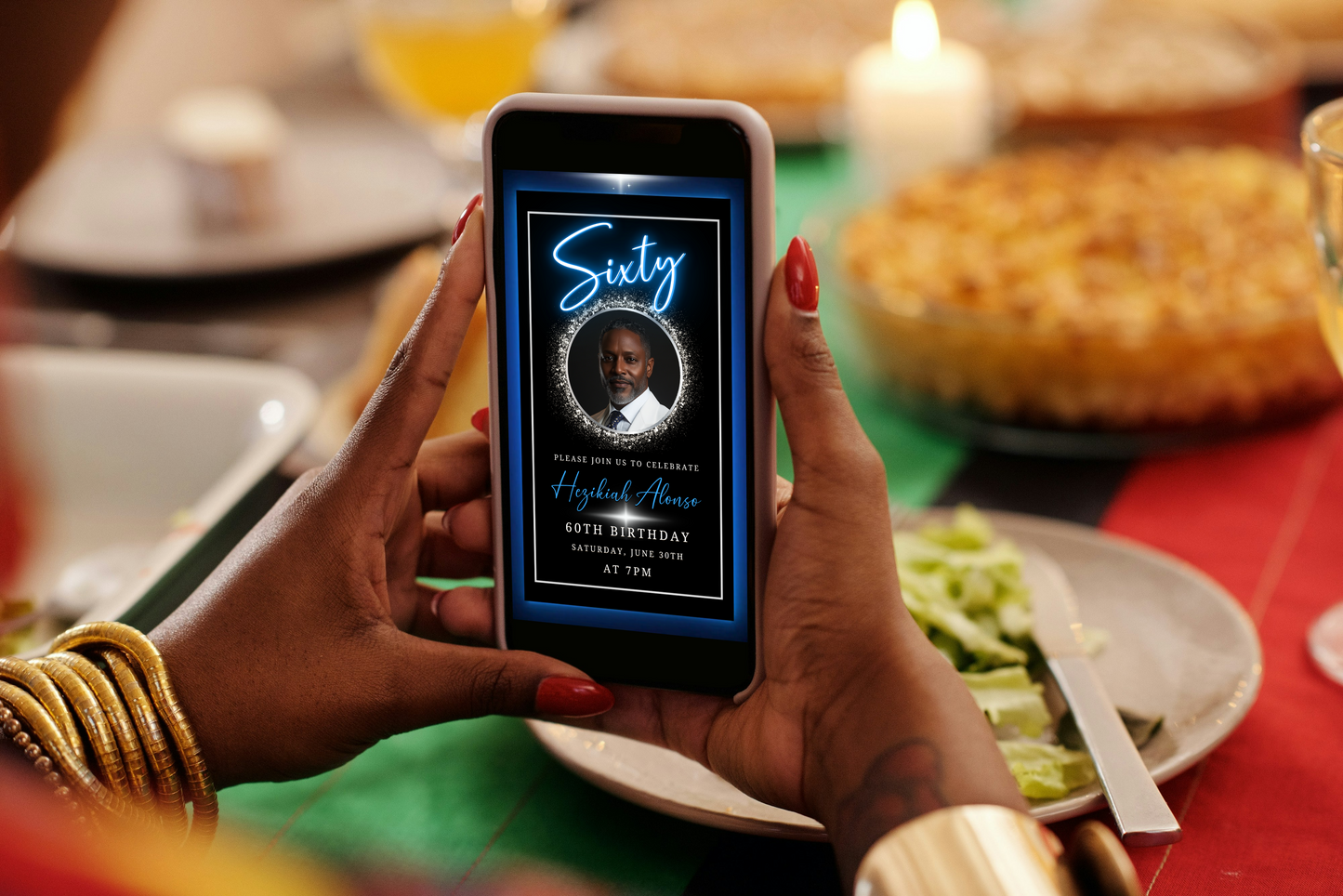 Person holding a phone displaying the Blue & Silver 70th Birthday Video Invitation with an elegant oval photo frame, highlighting its customizable features.