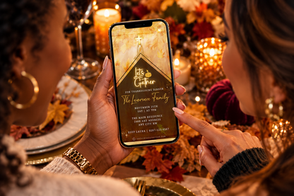 Two women at an autumn table view a gold-accented Thanksgiving video invitation on a phone.