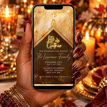 Hand with glittery nails holds phone displaying a gold cross Thanksgiving video invite, surrounded by autumn decor.