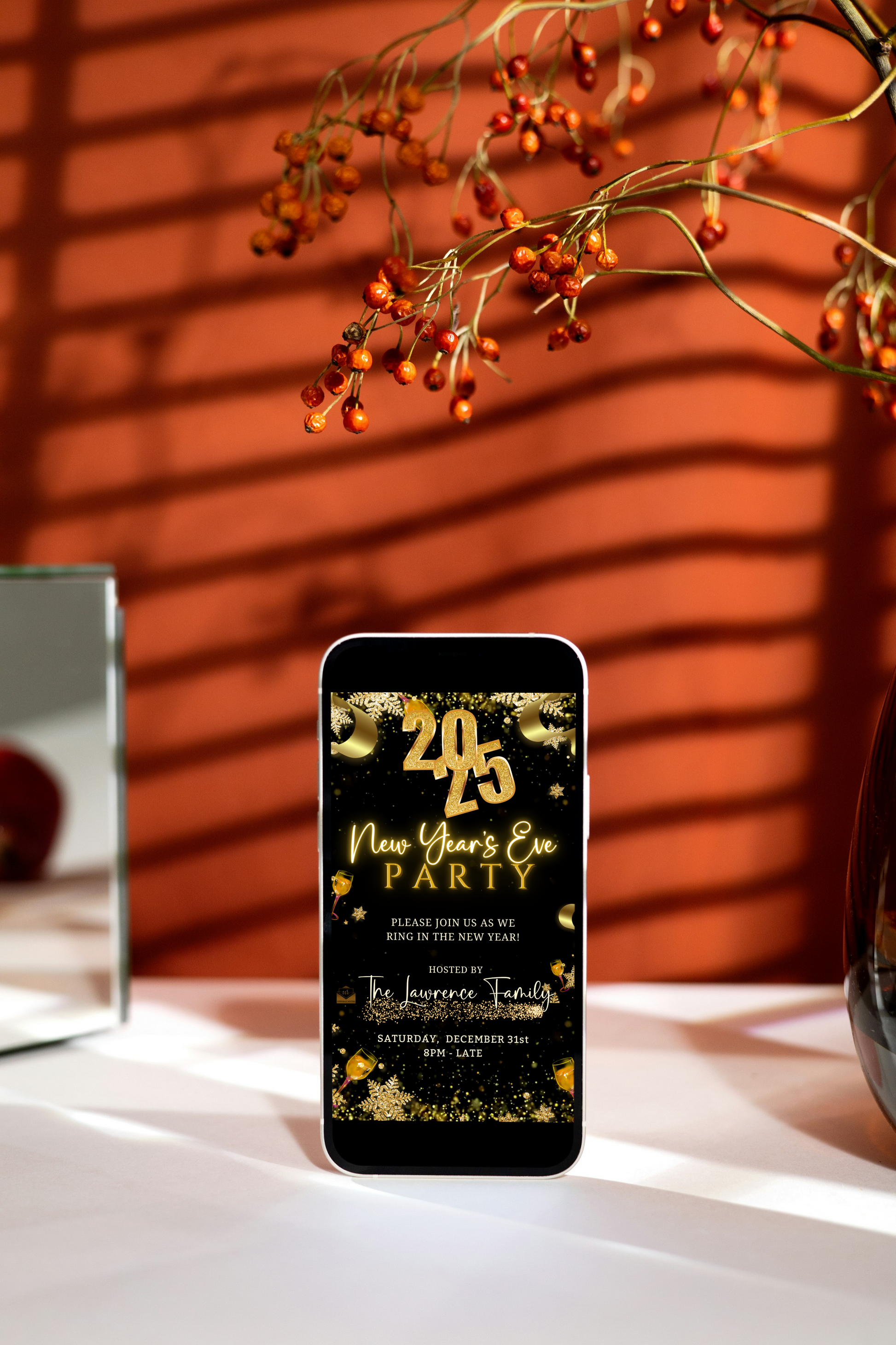 New Year’s Eve Party Sparkling Animated Video Invitation displayed on a table, featuring elegant gold and black designs for festive celebrations.