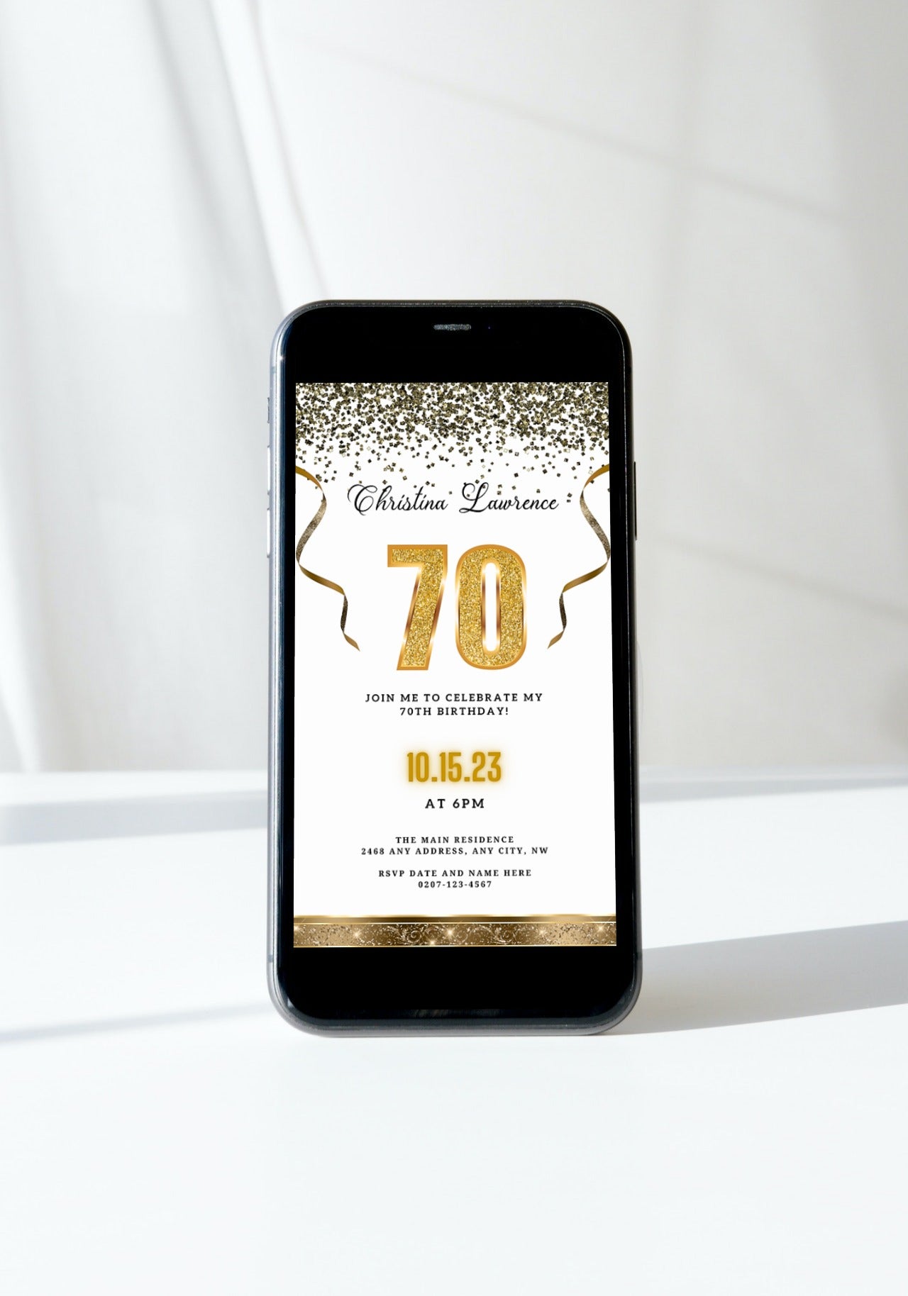 Customizable Digital White Gold Confetti 70th Birthday Evite displayed on a smartphone, featuring editable text and design elements for easy personalization using Canva.