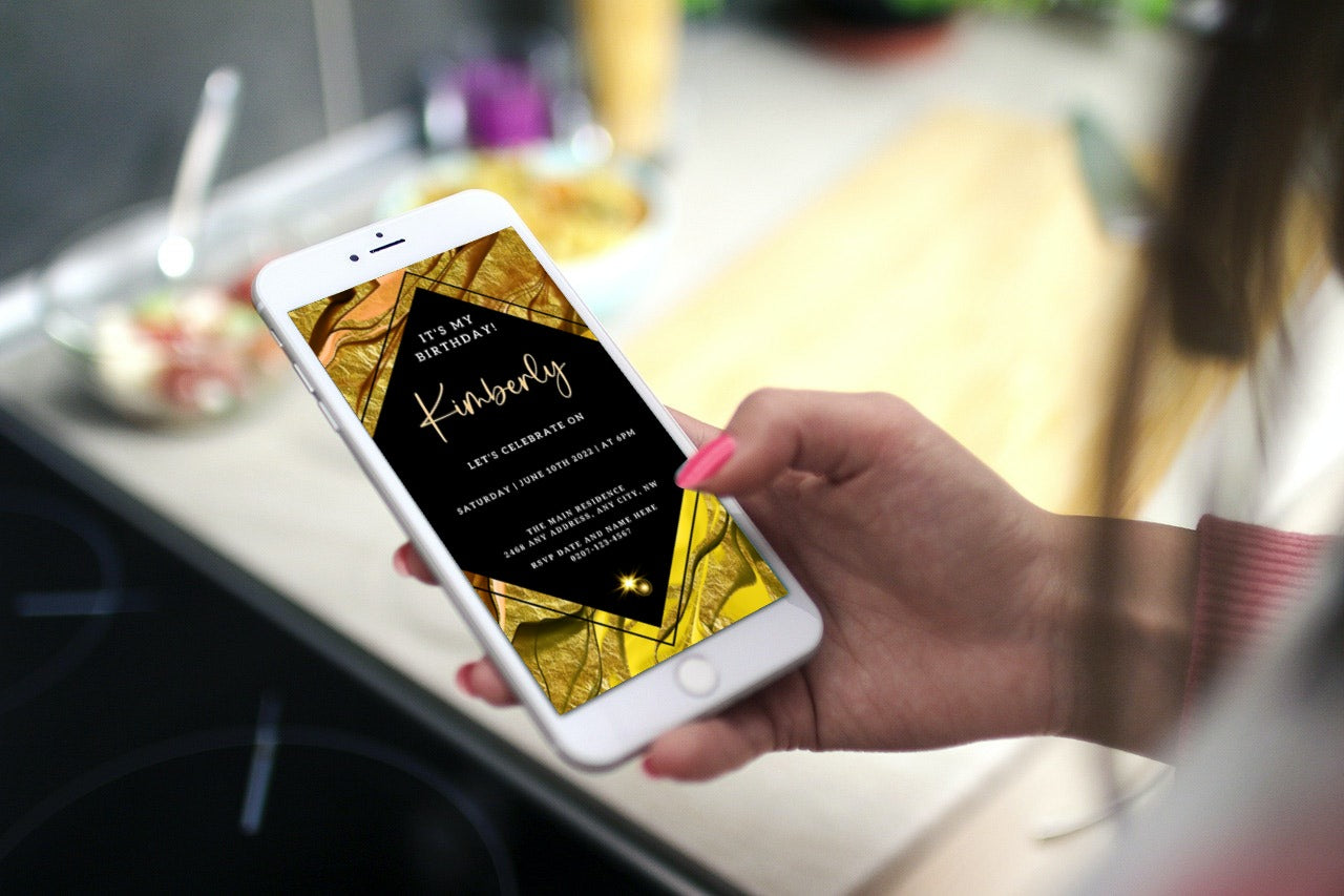 Hand holding a smartphone displaying a customizable Gold Black Ankara Birthday Evite template from URCordiallyInvited.