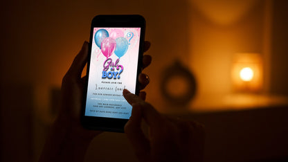 Person holding a smartphone displaying the customizable Pink Blue Floating Balloons Glitter Gender Reveal Party Evite from URCordiallyInvited.