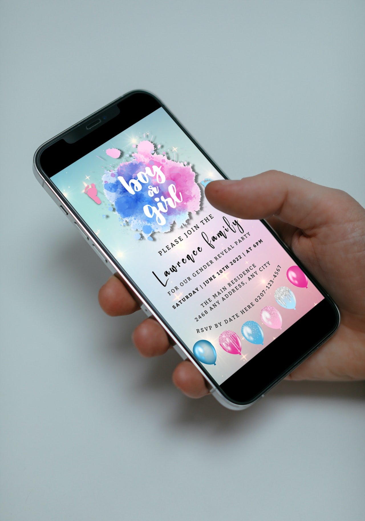 Hand holding a smartphone displaying a customizable Pink Blue Sparkle Feet Cloud Gender Reveal Evite template from URCordiallyInvited.