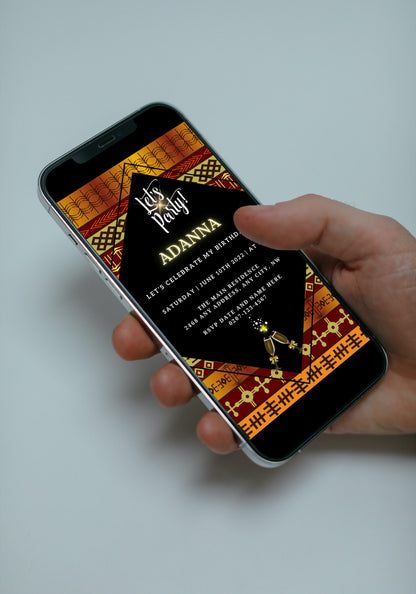 Hand holding a smartphone displaying a Gold Yellow African Ankara Editable Party Evite, customizable via Canva for digital sharing.