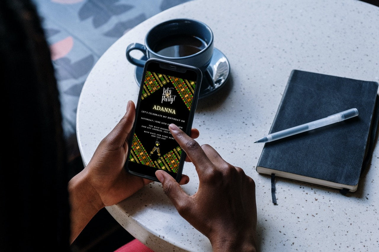 Person holding a smartphone displaying the Green Black African Ankara Editable Party Evite template for customizing event invitations via Canva.