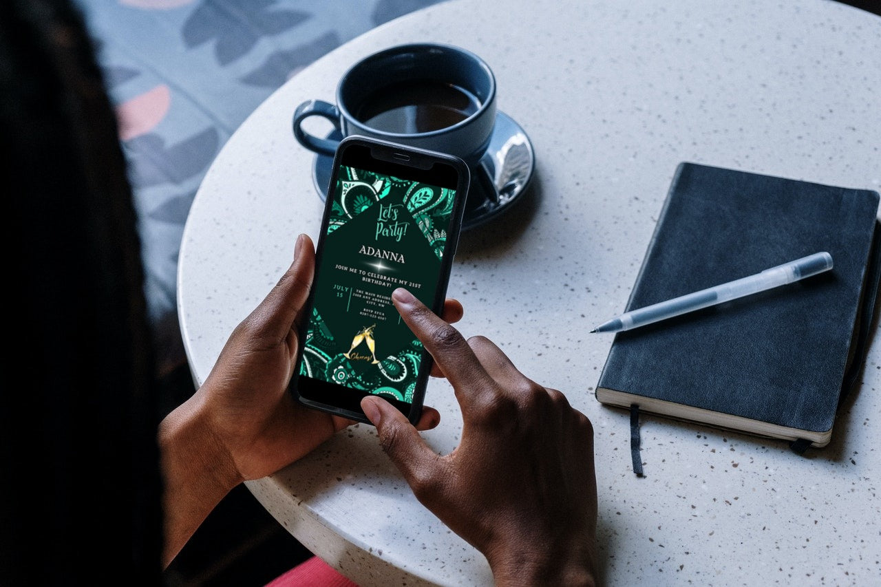 Person holding a smartphone displaying the Green White African Ankara editable party evite from URCordiallyInvited.