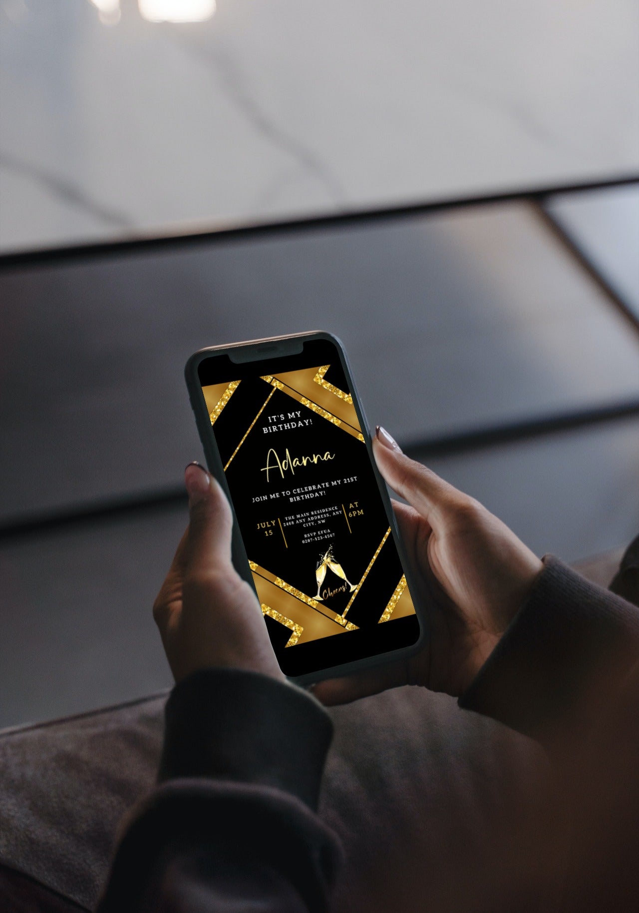 A person holding a phone displaying a customizable Gold Black Glitter Champagne party invitation template.