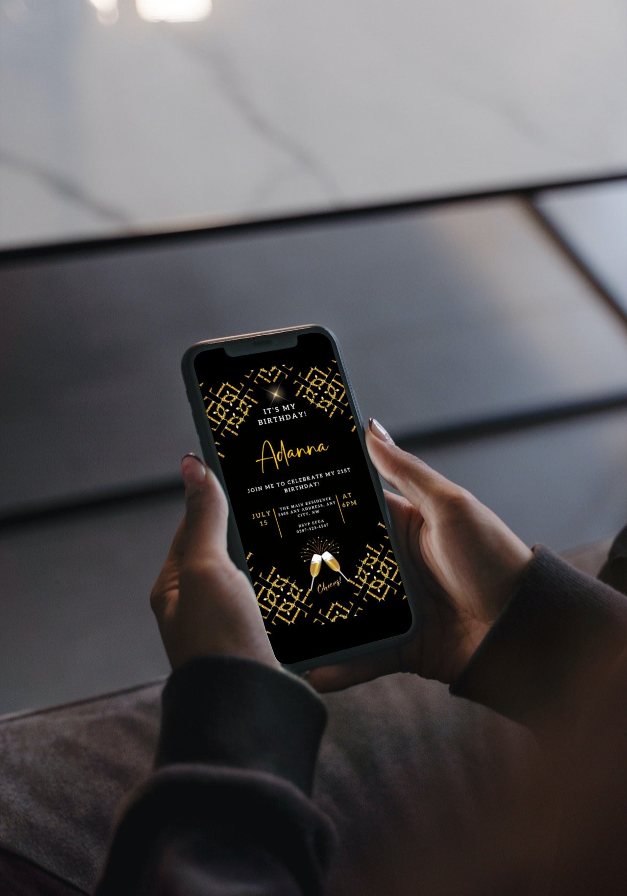 Person holding smartphone displaying African Gold Black Sparkle Customisable Birthday Evite from URCordiallyInvited, showcasing editable digital invitation template.