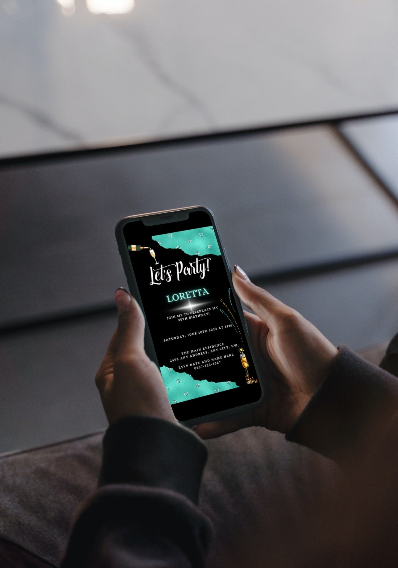 Person holding a smartphone displaying the Black Teal Diamond Sparkle | Customisable Party Evite from URCordiallyInvited, ready for personalizing via the Canva app.