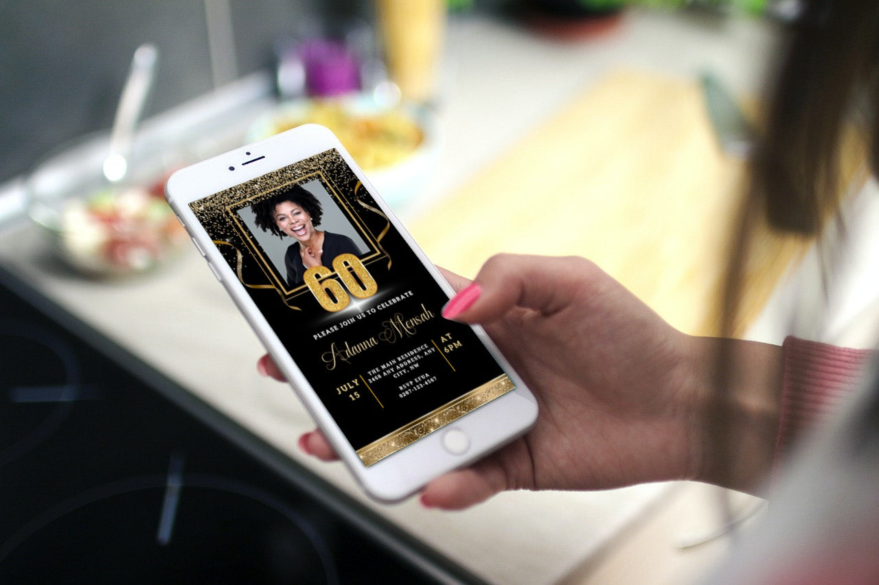 Hand holding a phone displaying a customizable Digital Black Gold Confetti 60th Birthday Evite with a woman's photo. Editable via Canva for easy personalization.