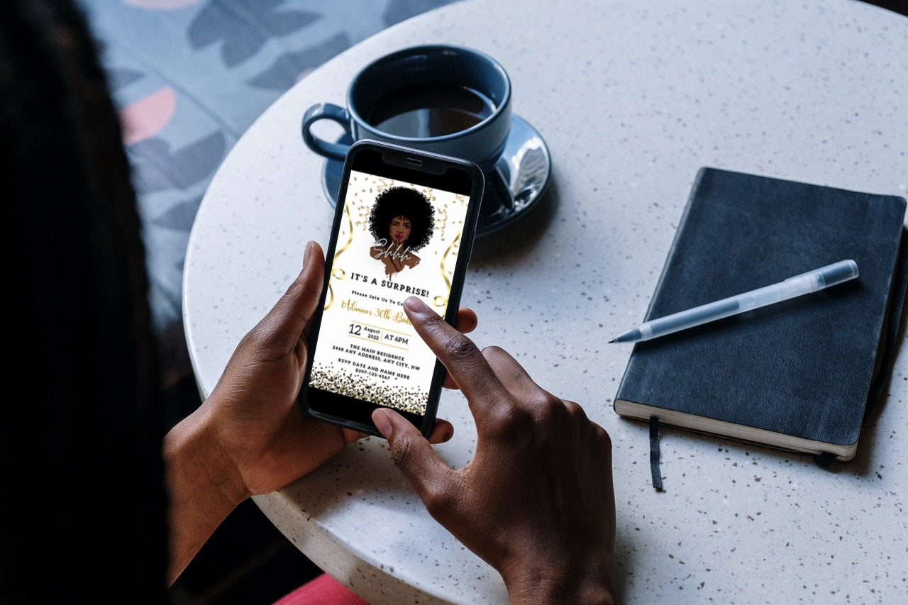 Person holding a smartphone with an editable Afro Girl Magic Surprise party evite displayed, customizable via Canva for easy digital invitations.