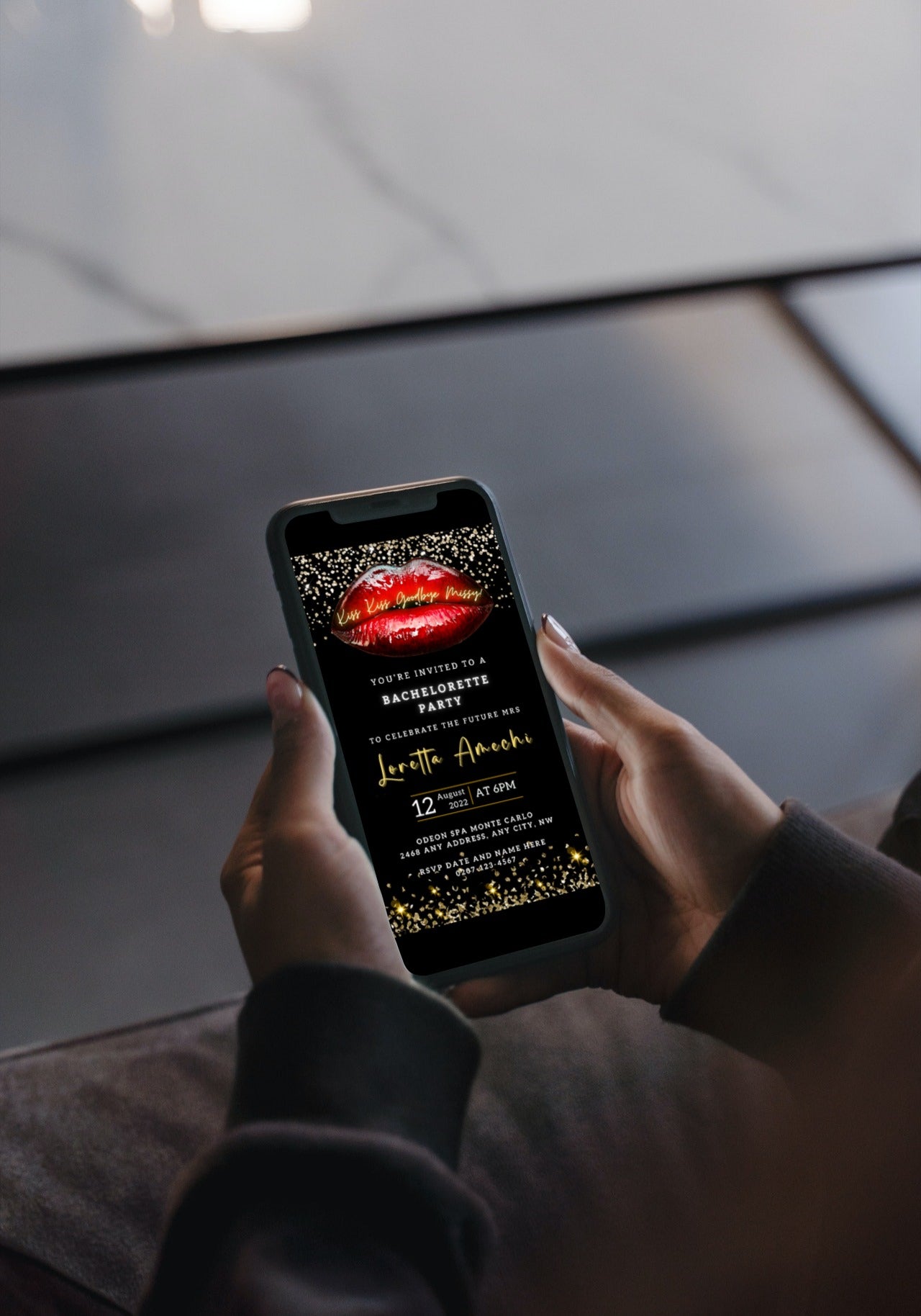 Person holding a smartphone displaying a customizable digital invitation template for a Bachelorette Party with Hot Red Lips and Gold Glitter accents.