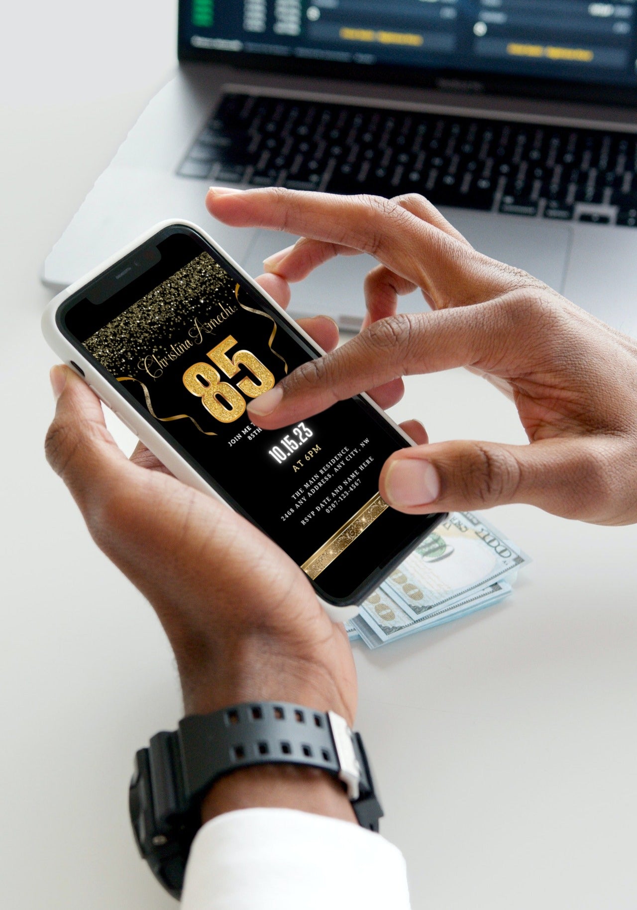 Person holding a smartphone displaying the customizable Digital Black Gold Confetti 85th Birthday Evite template from URCordiallyInvited.