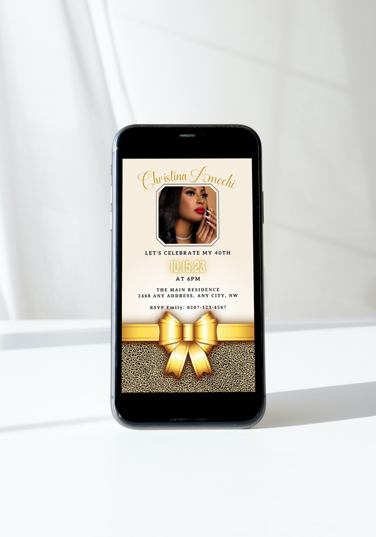 Cell phone with a customizable digital invitation displaying a woman's face and a gold bow, ideal for a 40th birthday.