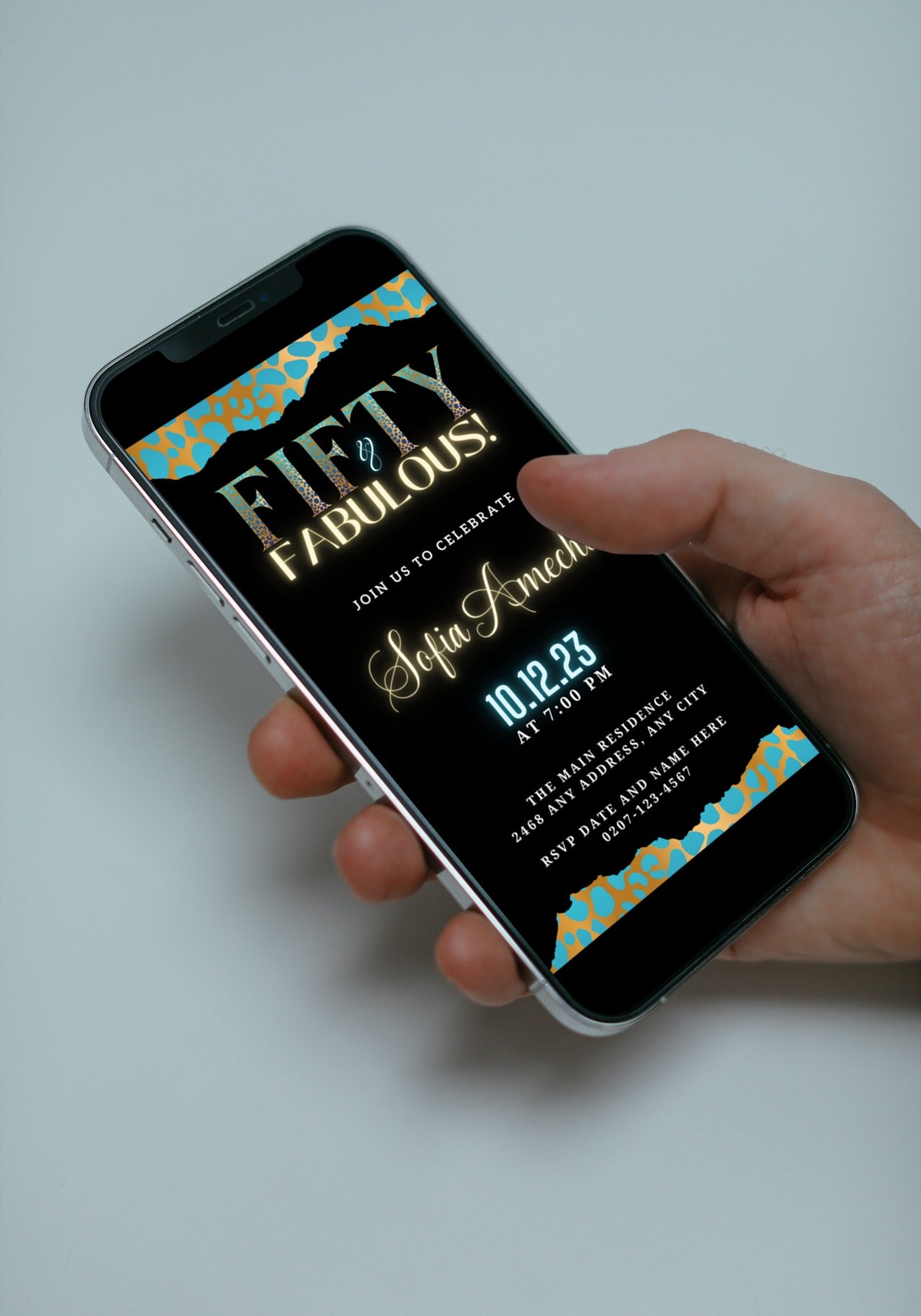 Hand holding a smartphone displaying a customizable Teal Gold Cheetah Leopard | 50 & Fabulous Party Evite, designed for easy personalization and digital sharing.