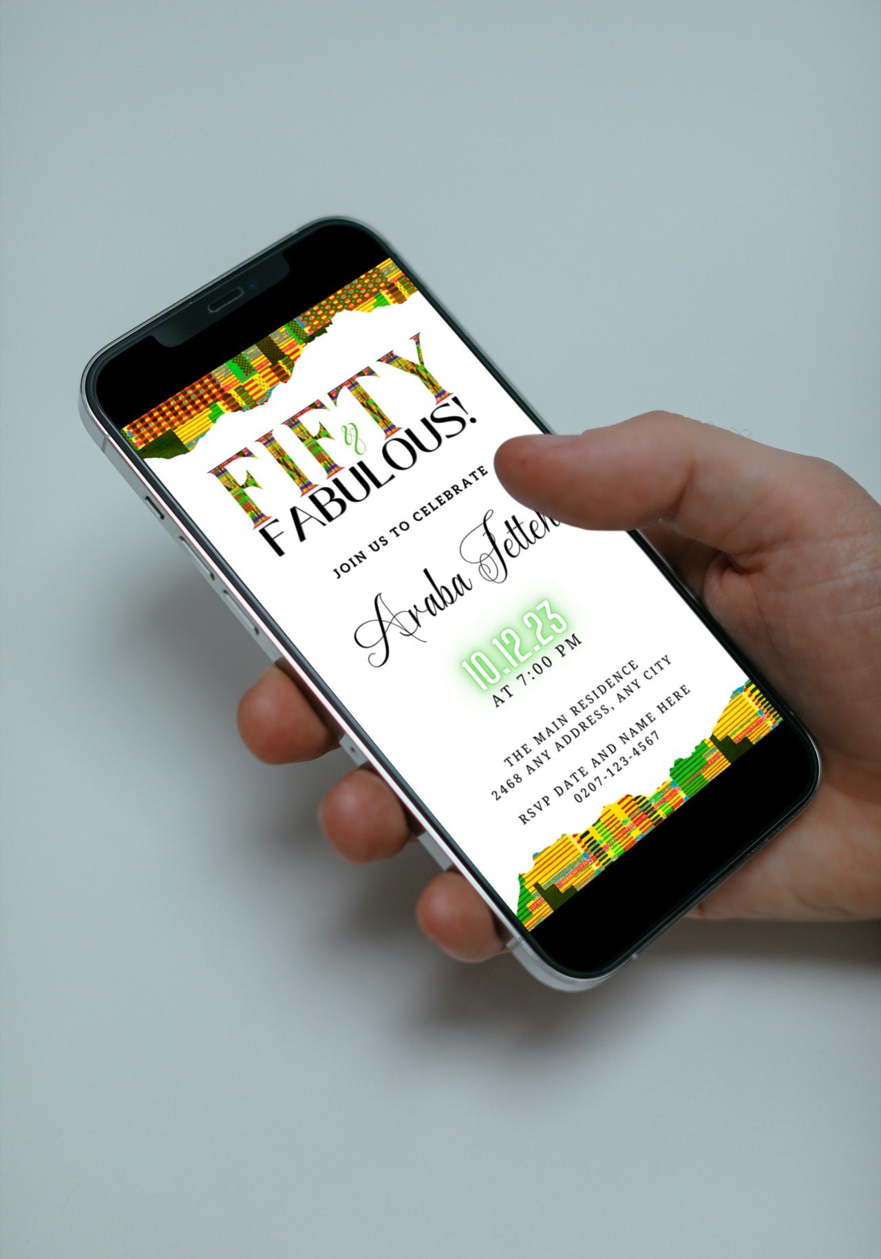 A hand holding a smartphone displaying the customizable Green Yellow Kente White | 50 & Fabulous Party Evite invitation template.