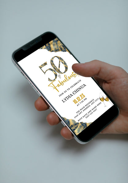 Hand holding a smartphone displaying the Gold Blue Tropical | 50 & Fabulous Party Evite template for custom digital invitations.
