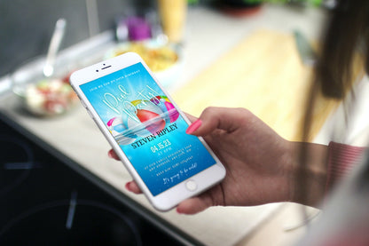 Hand holding a smartphone displaying the customizable Digital Aqua Pool Party Invitation template from URCordiallyInvited.