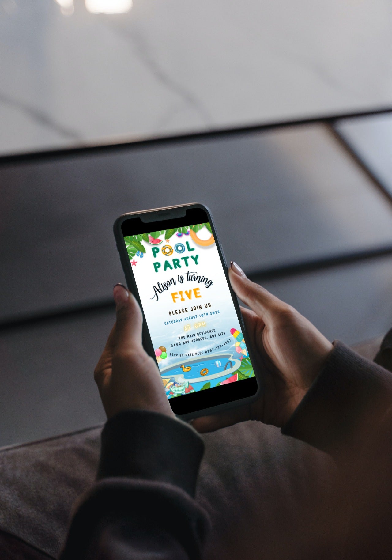 Person holding smartphone displaying customizable digital Kids Birthday Pool Party invitation template from URCordiallyInvited.