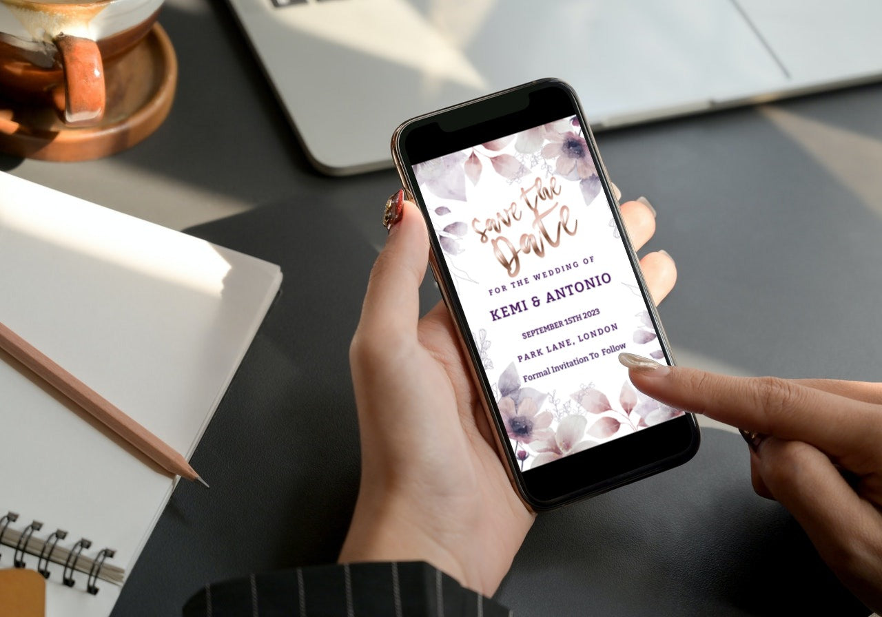 Person holding a smartphone displaying a Boho Rustic Floral Save The Date Evite, customizable via Canva for digital invitations.